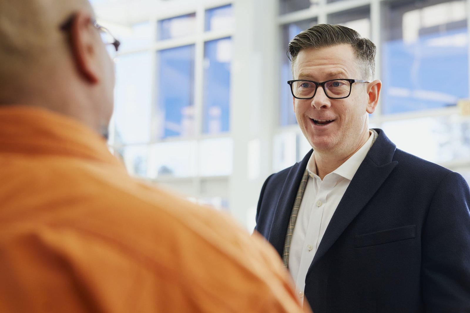 two men talking on focus photography