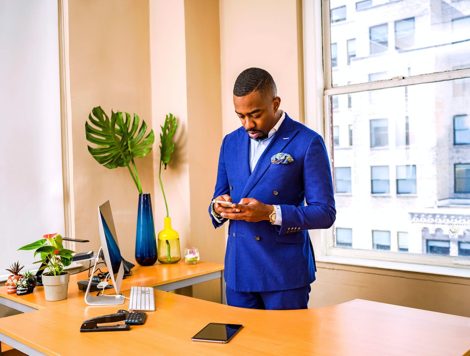 man standing while using phone