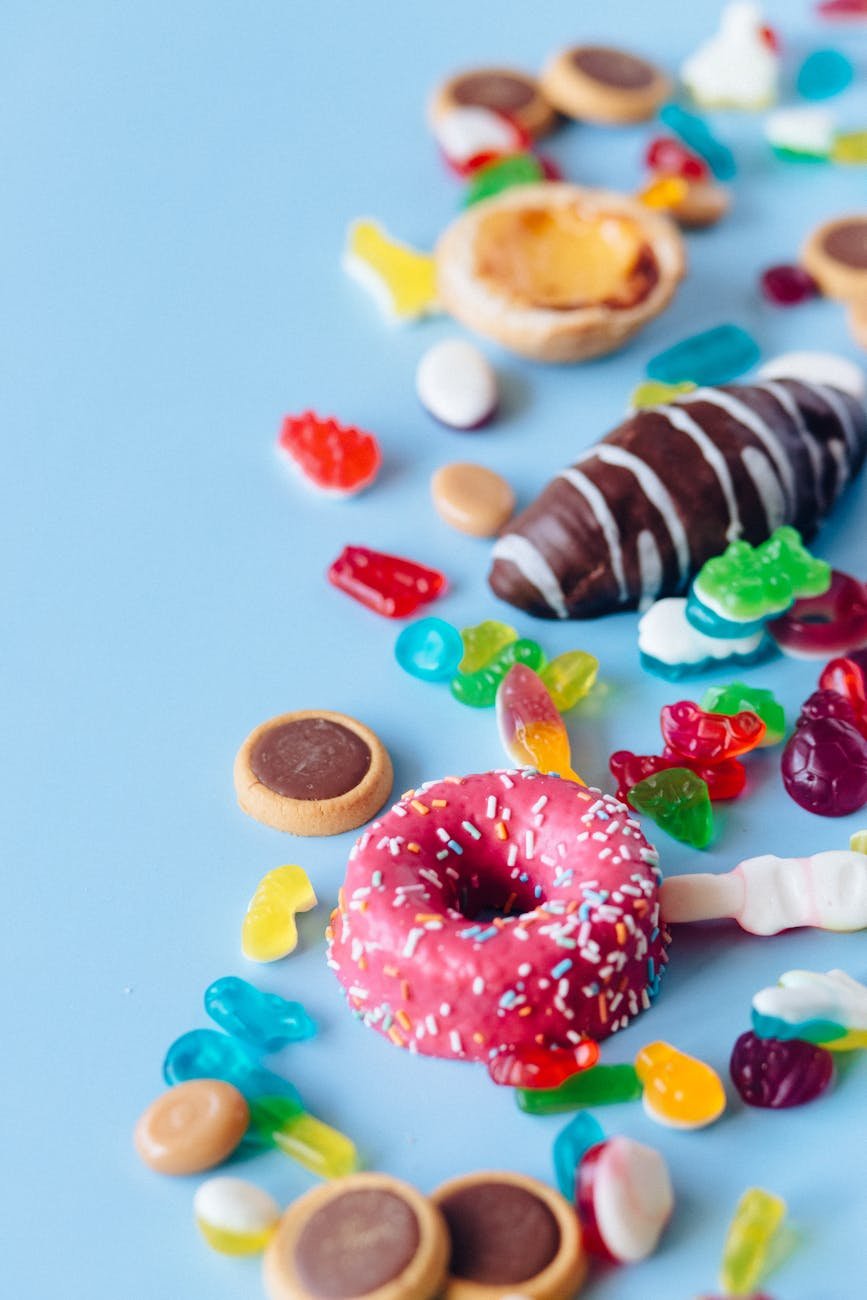 colorful candies and sweet foods on a blue surface